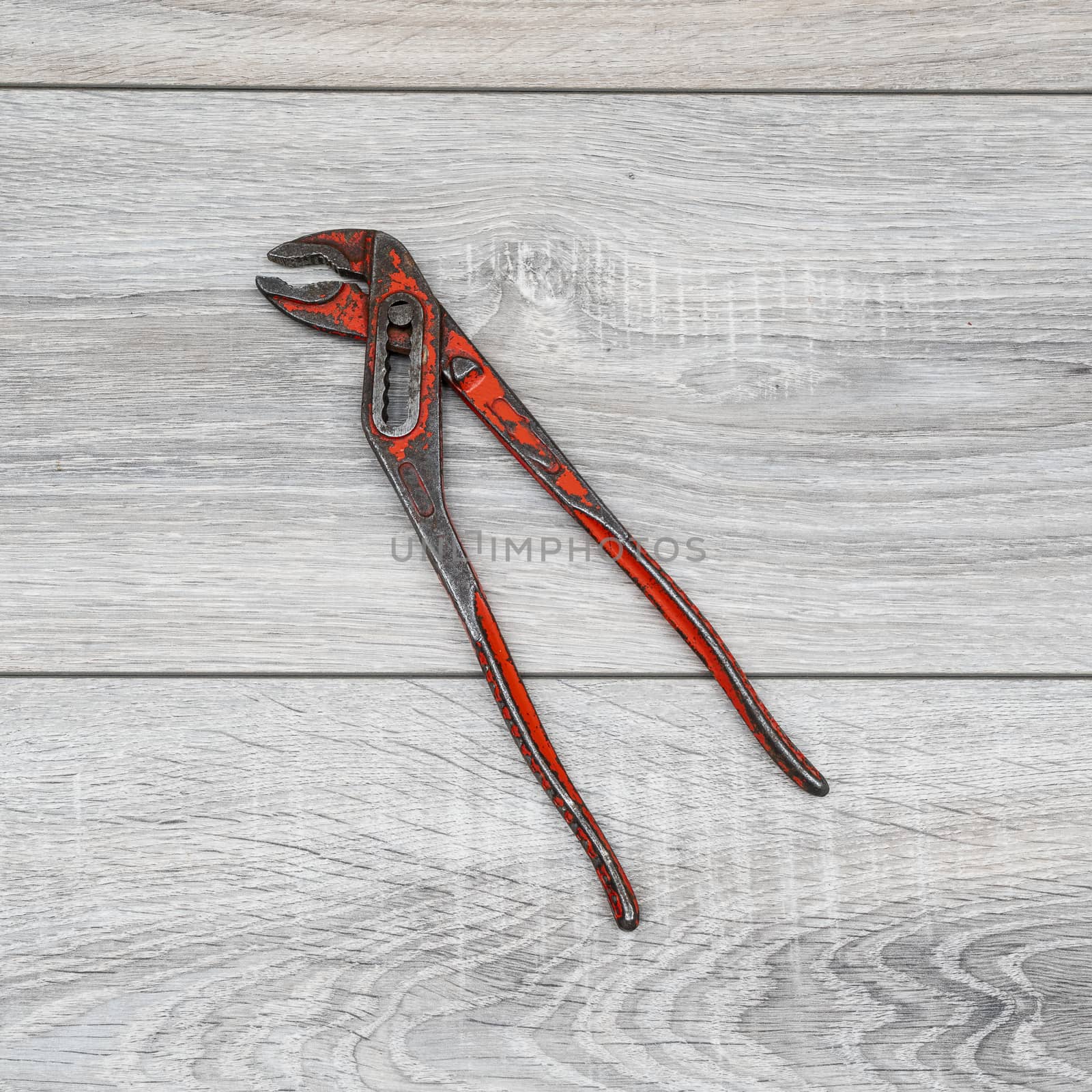 a pipe wrench on a wooden table