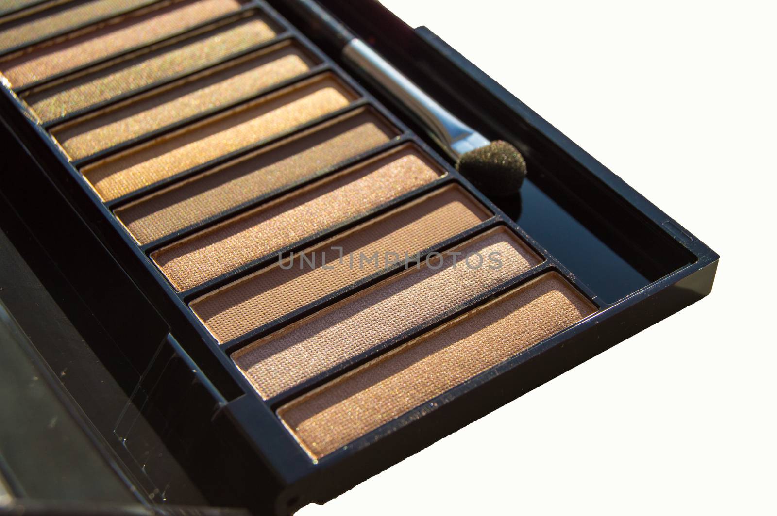 Cosmetic set of Nude eyeshadow with brush in black case isolated on white background.