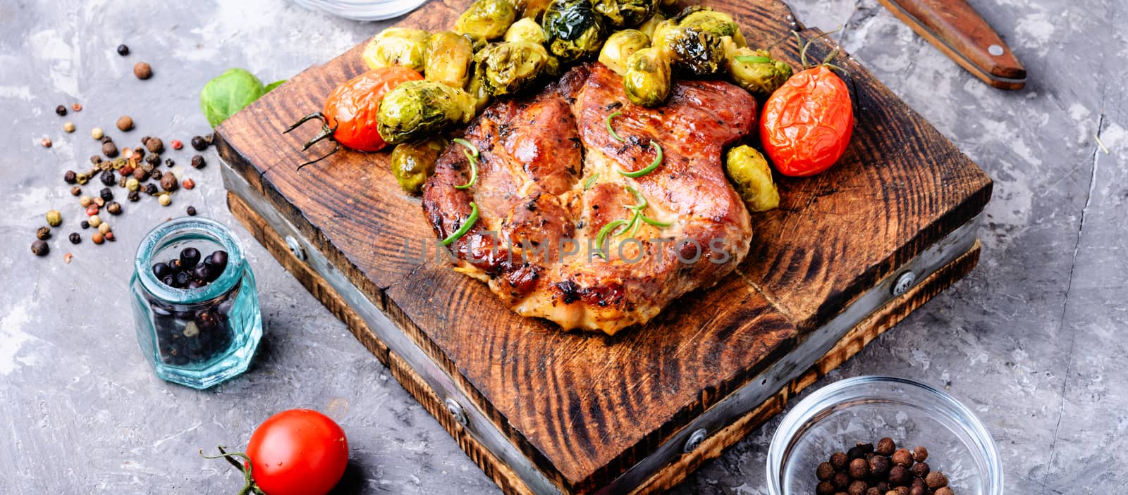 Grilled meat steak with vegetables on the kitchen board. Grilled meat with Brussels sprouts