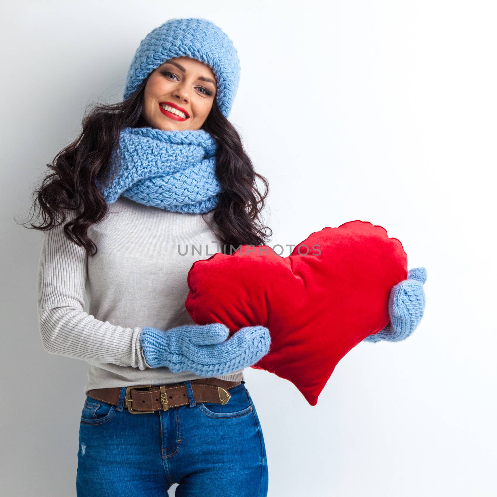 Woman in hat holding heart by Yellowj