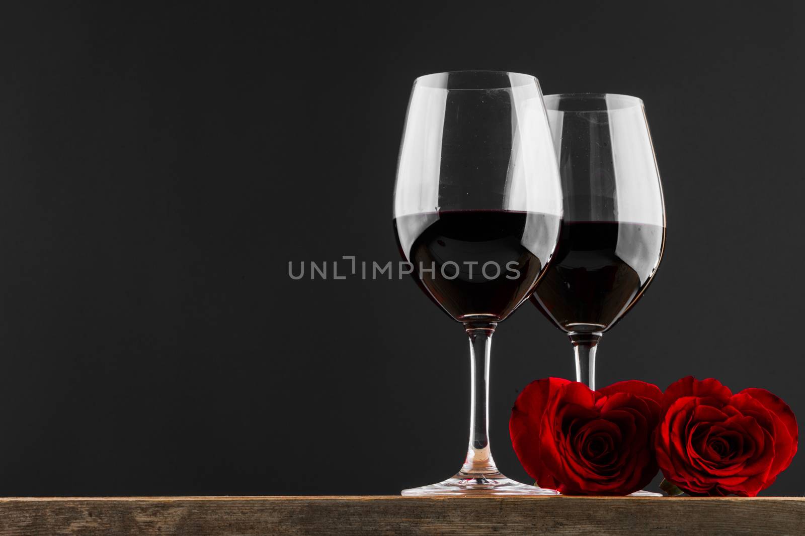 Two glasses of red wine and heart shaped roses, Valentine day