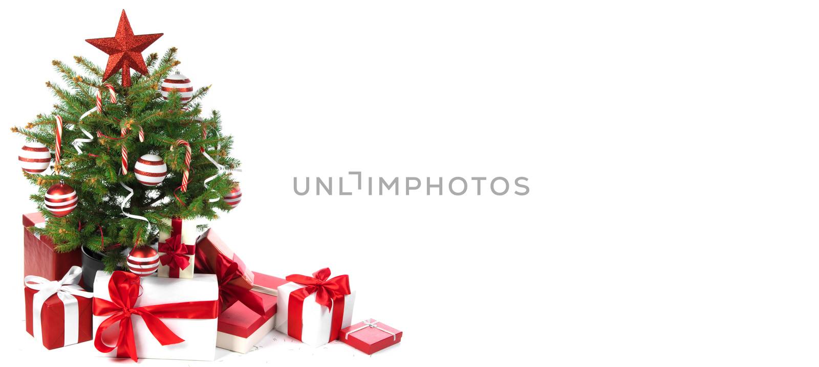 Decorated Christmas tree with gift boxes isolated on white background