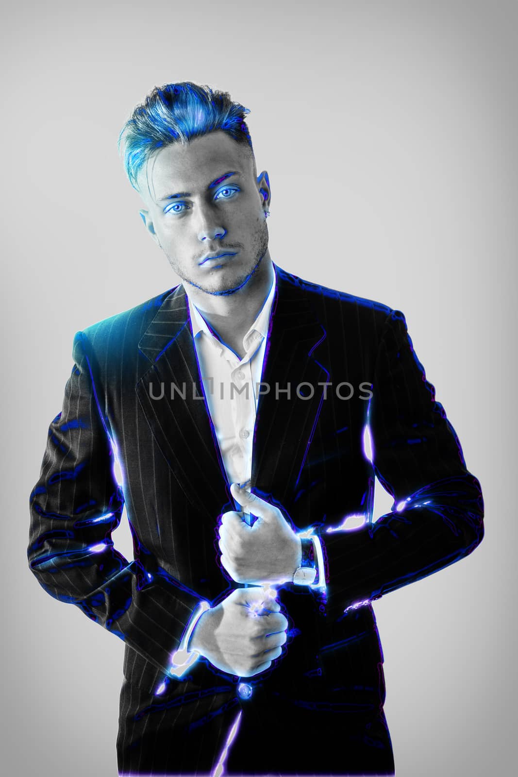 Handsome modern man wearing jacket and looking confidently at camera in blue glowing effect