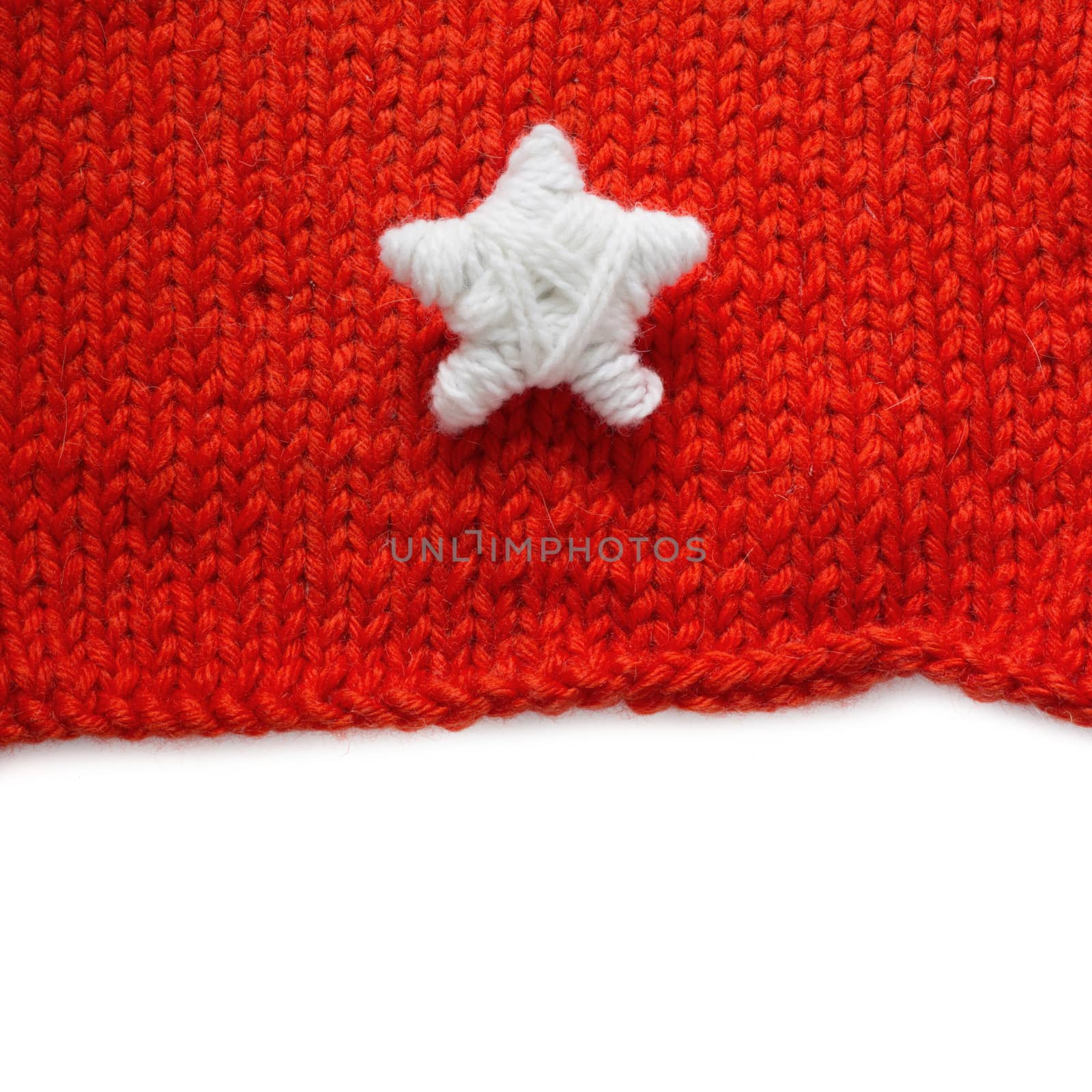 Handmade Christmas Star on red knitted woolen background isolated on white background with copy space for text