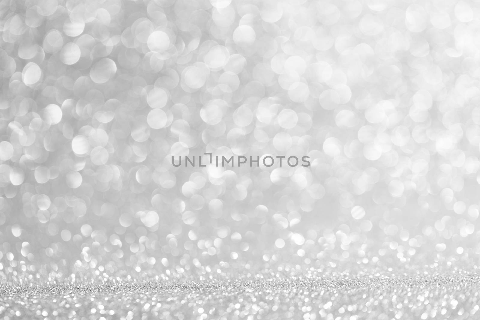 Abstract shining glitters silver holiday bokeh background with copy space for text