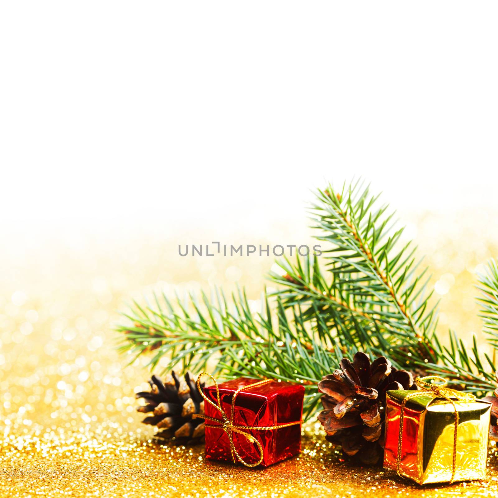 Christmas card with fir branch and decorations on golden gitter background