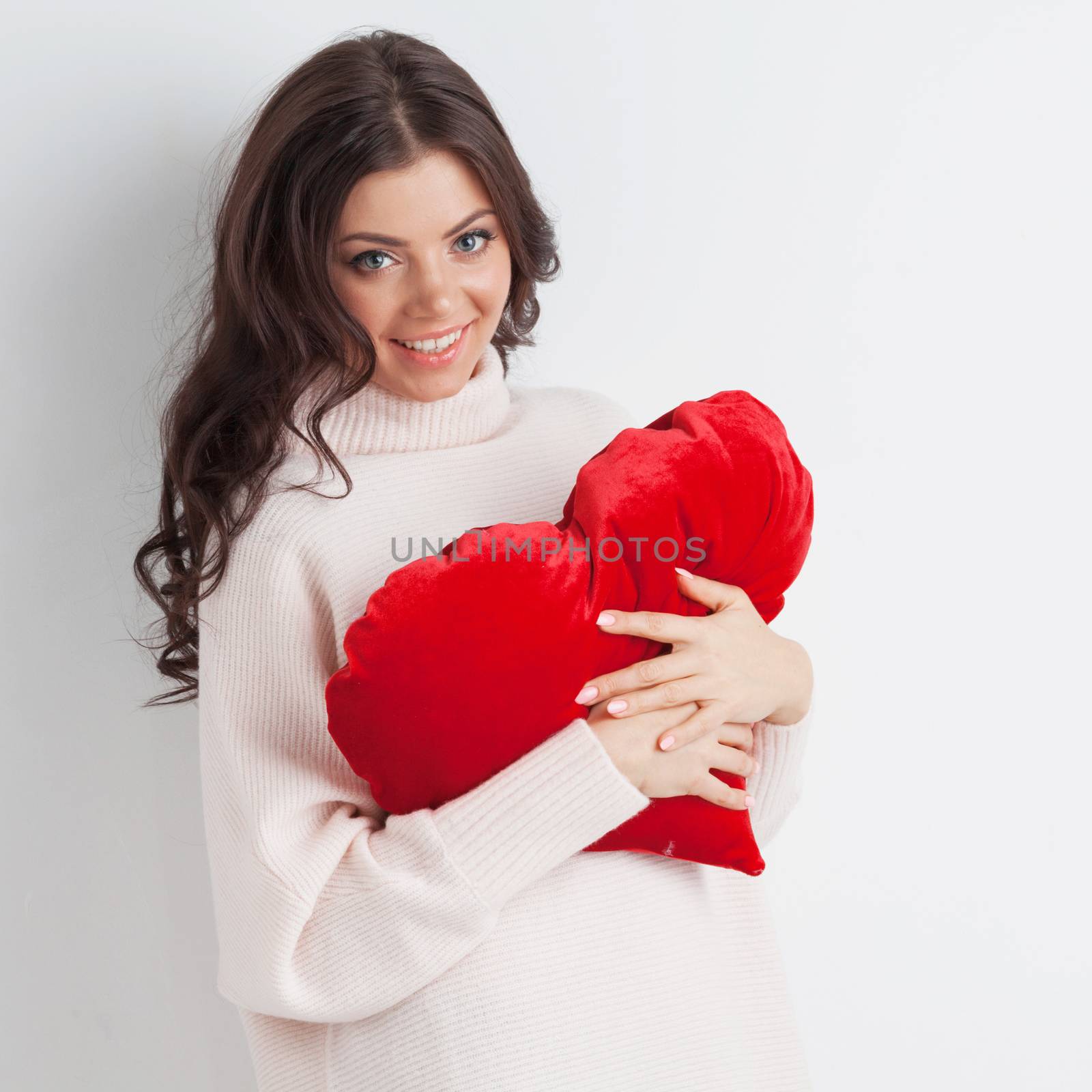 Beautiful woman with red pillow heart, valentine's day concept