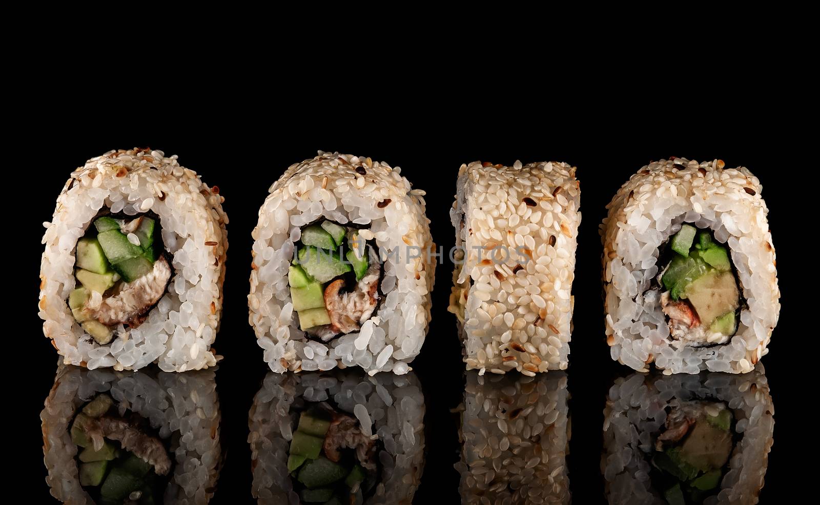 Several sushi california rolls in a row. Black background. Reflection.