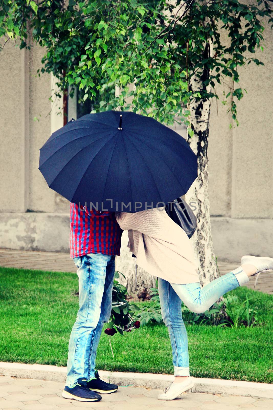 lovers unde an umbrella on a date. photo by Irinavk