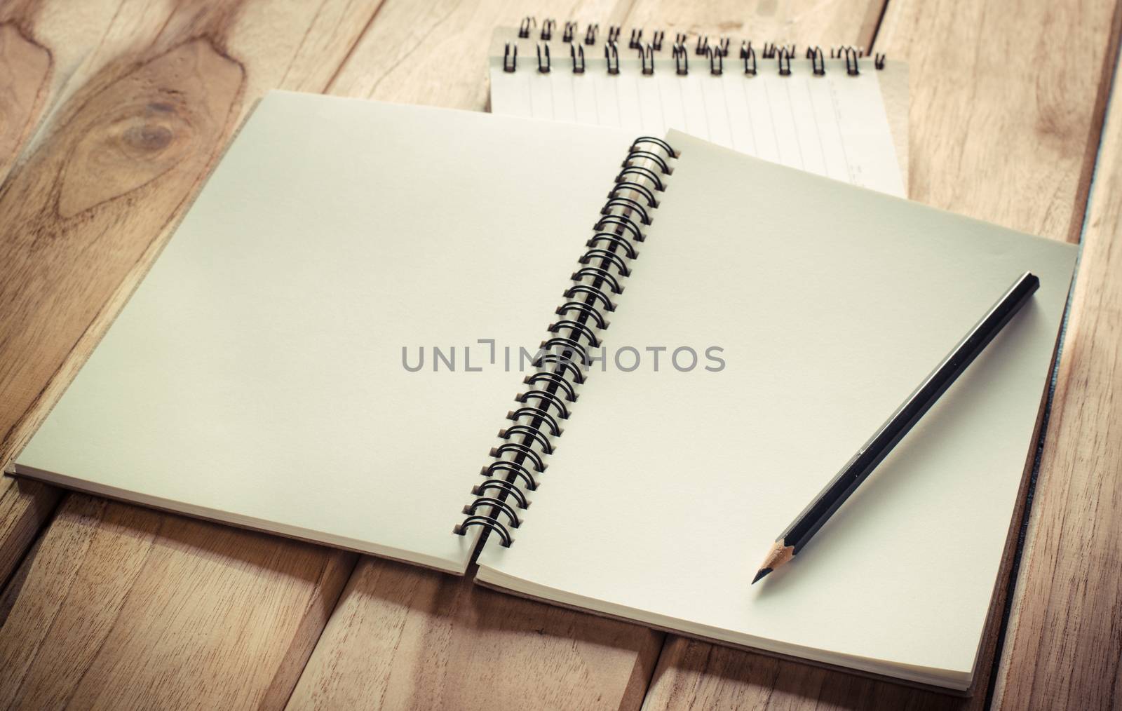 blank notebook with pencil on wooden table - still life