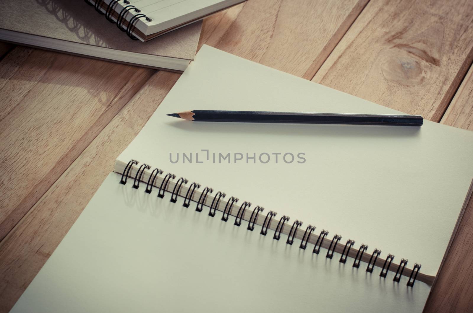 blank notebook with pencil on wooden table - still life