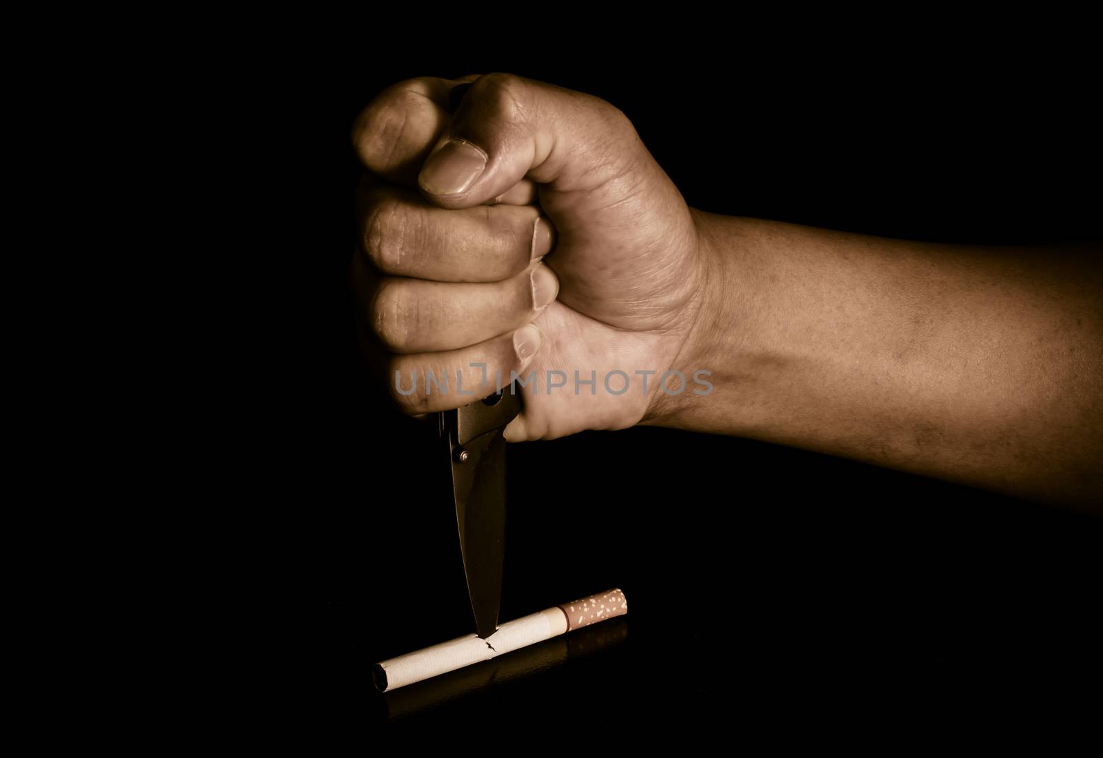 Handle knife stabbed into cigarettes concept eliminate smoking, quit smoking.