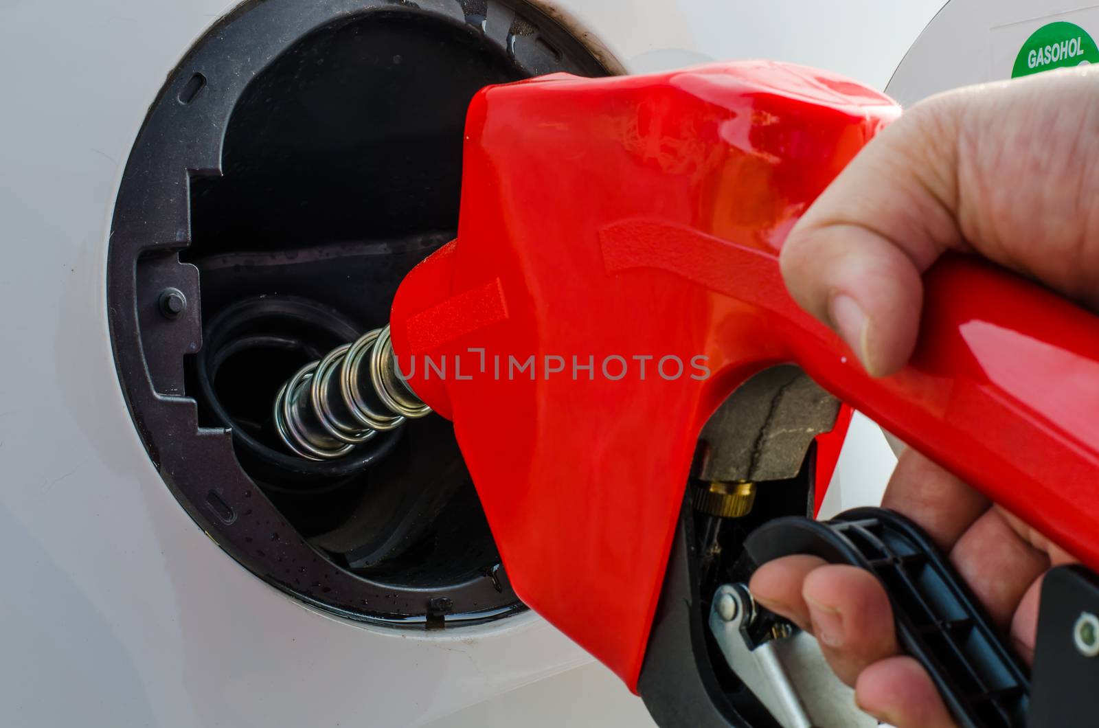 Fuel nozzle add fuel in car  by photobyphotoboy