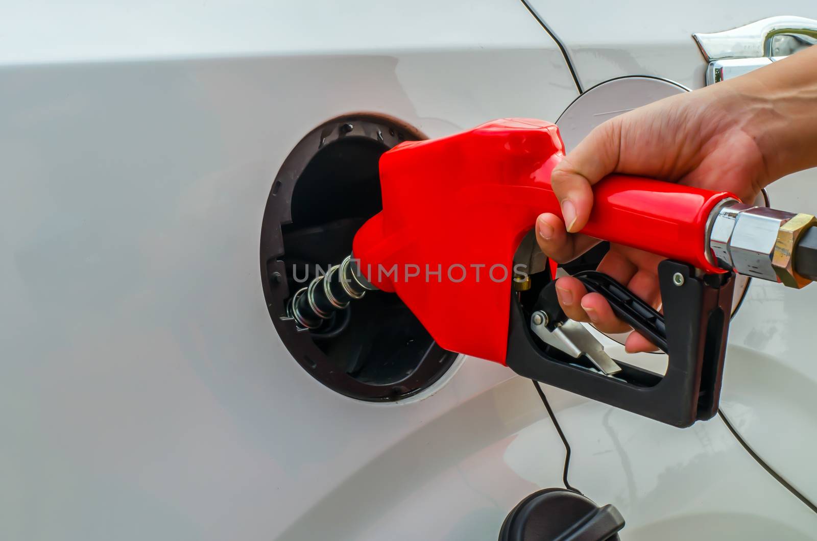 Fuel nozzle add fuel in car  by photobyphotoboy