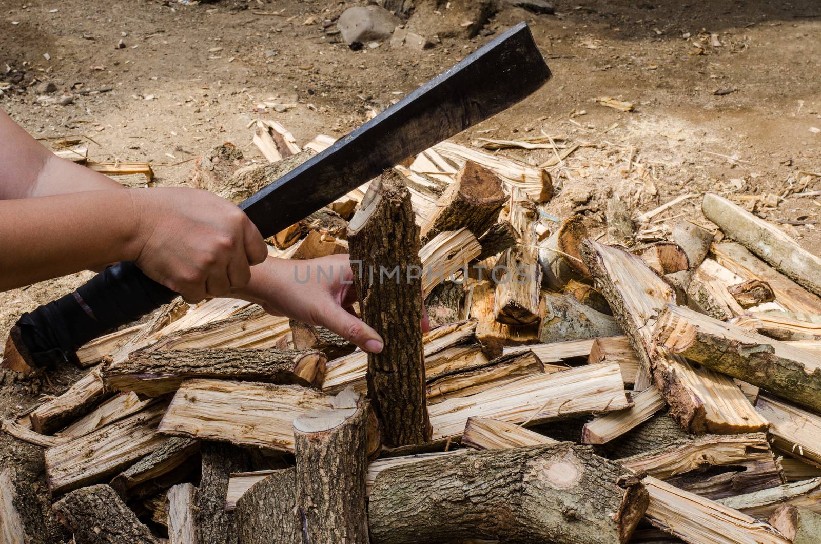 Holding a knife to cut firewood by photobyphotoboy