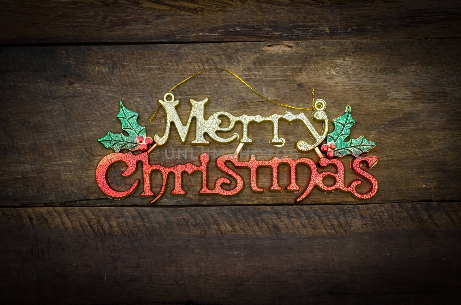 Merry Christmas greeting message on wooden background by photobyphotoboy