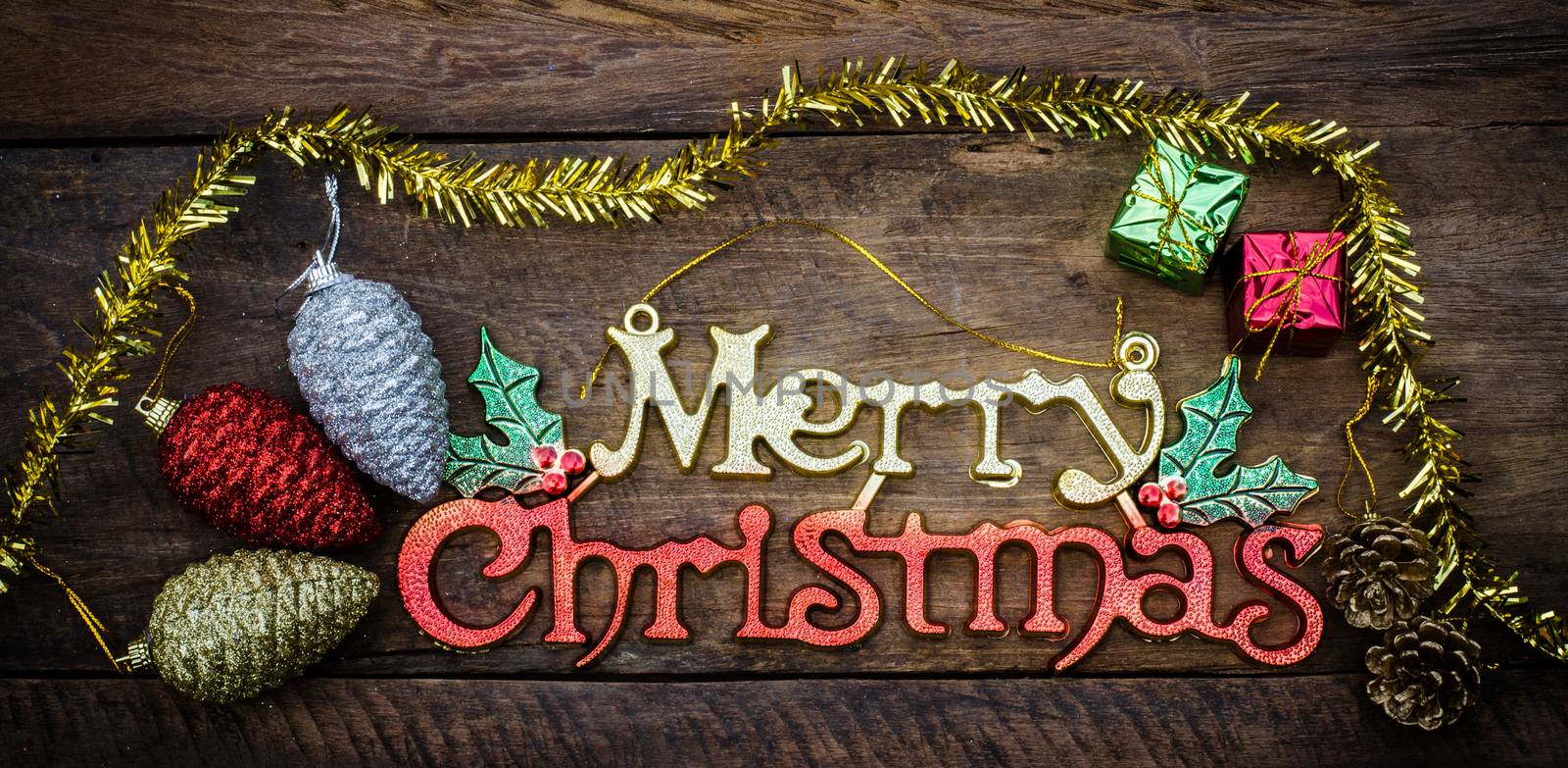 Merry Christmas greeting message on wooden background by photobyphotoboy