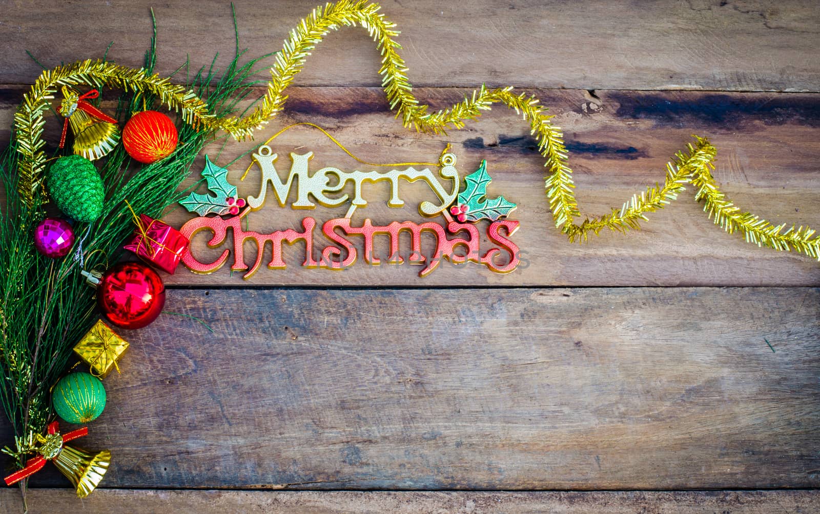 Merry Christmas greeting message on wooden background by photobyphotoboy