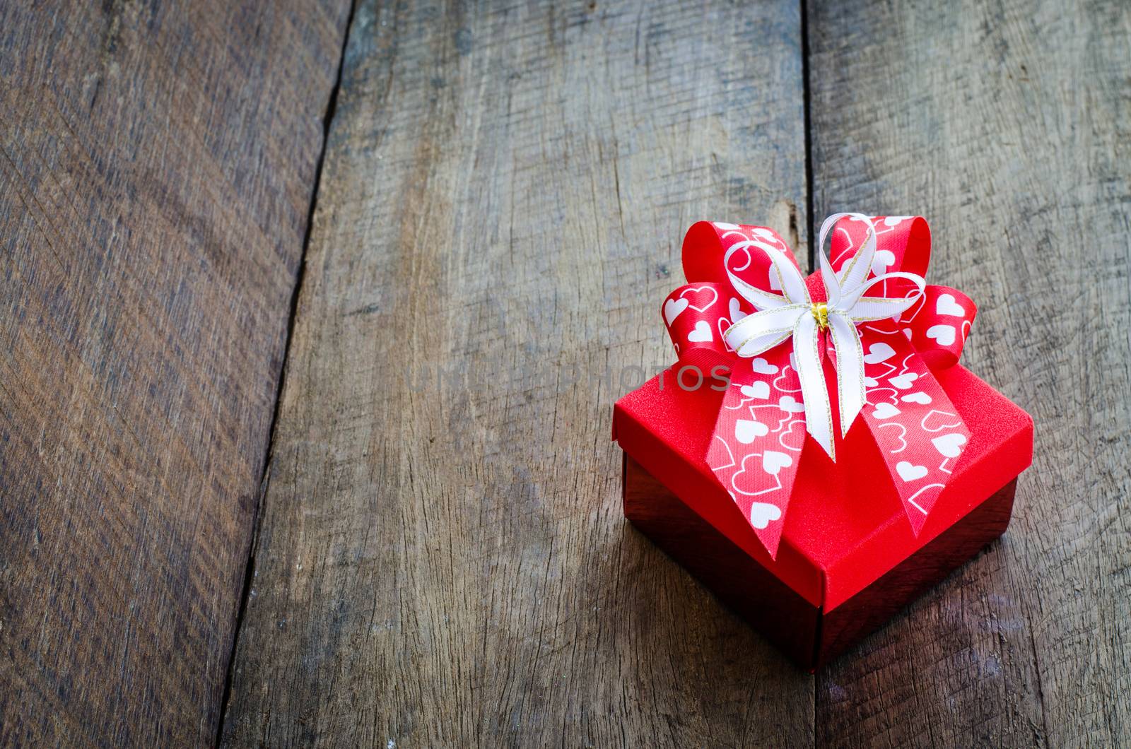 gift box on wooden background. by photobyphotoboy