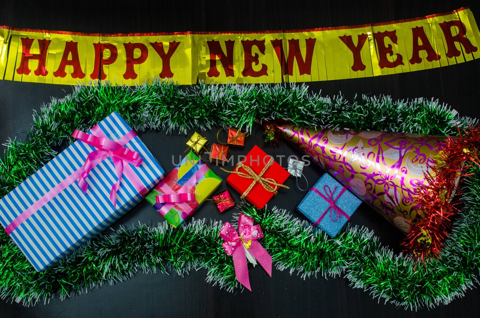 happy New Year message and  gift box on wooden background. by photobyphotoboy