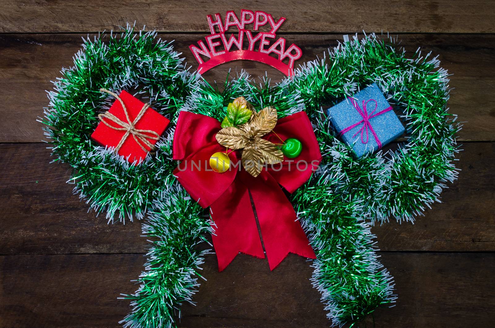 happy New Year message and gift box on wooden background. by photobyphotoboy