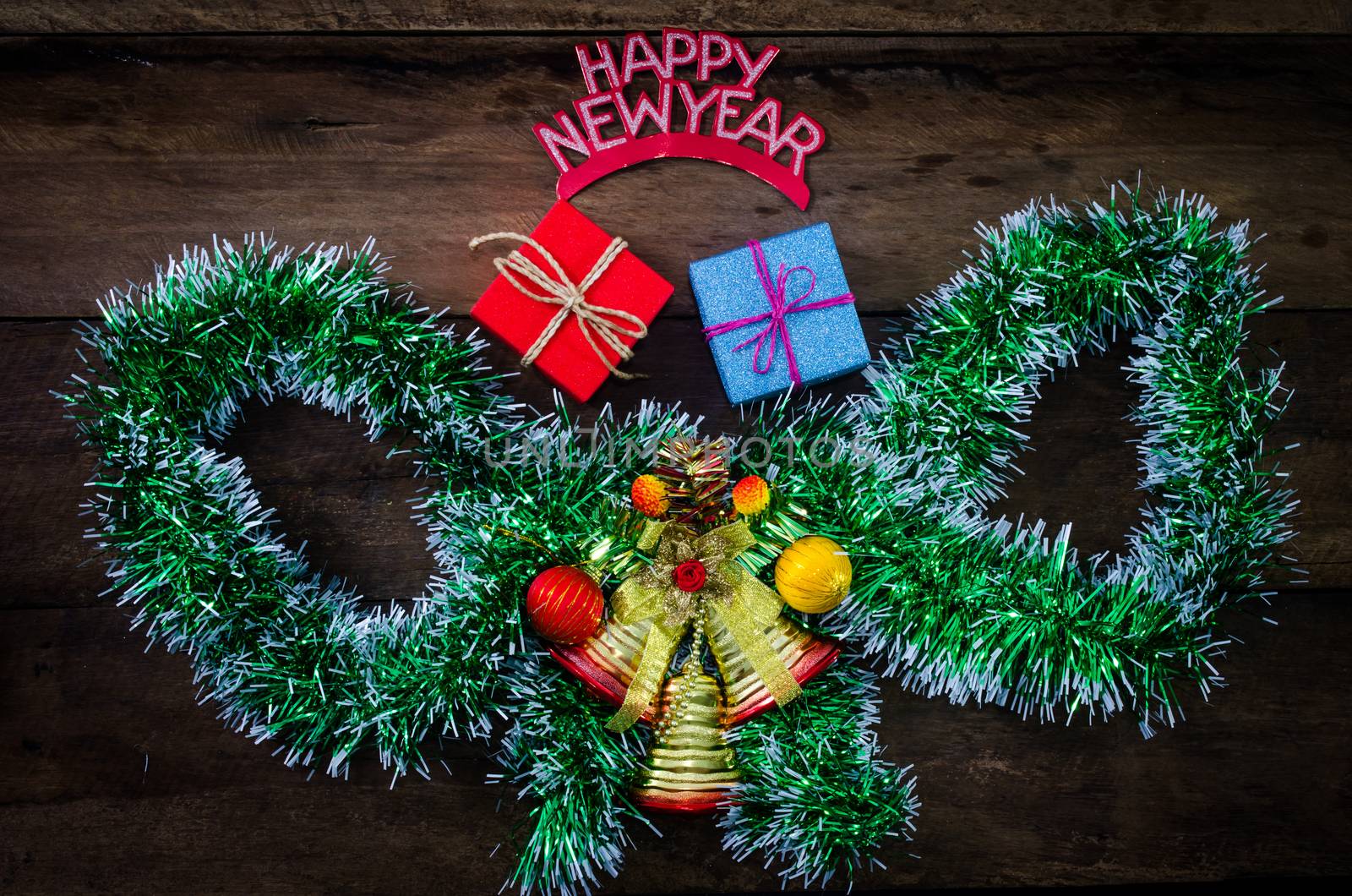 happy New Year message and gift box on wooden background. by photobyphotoboy