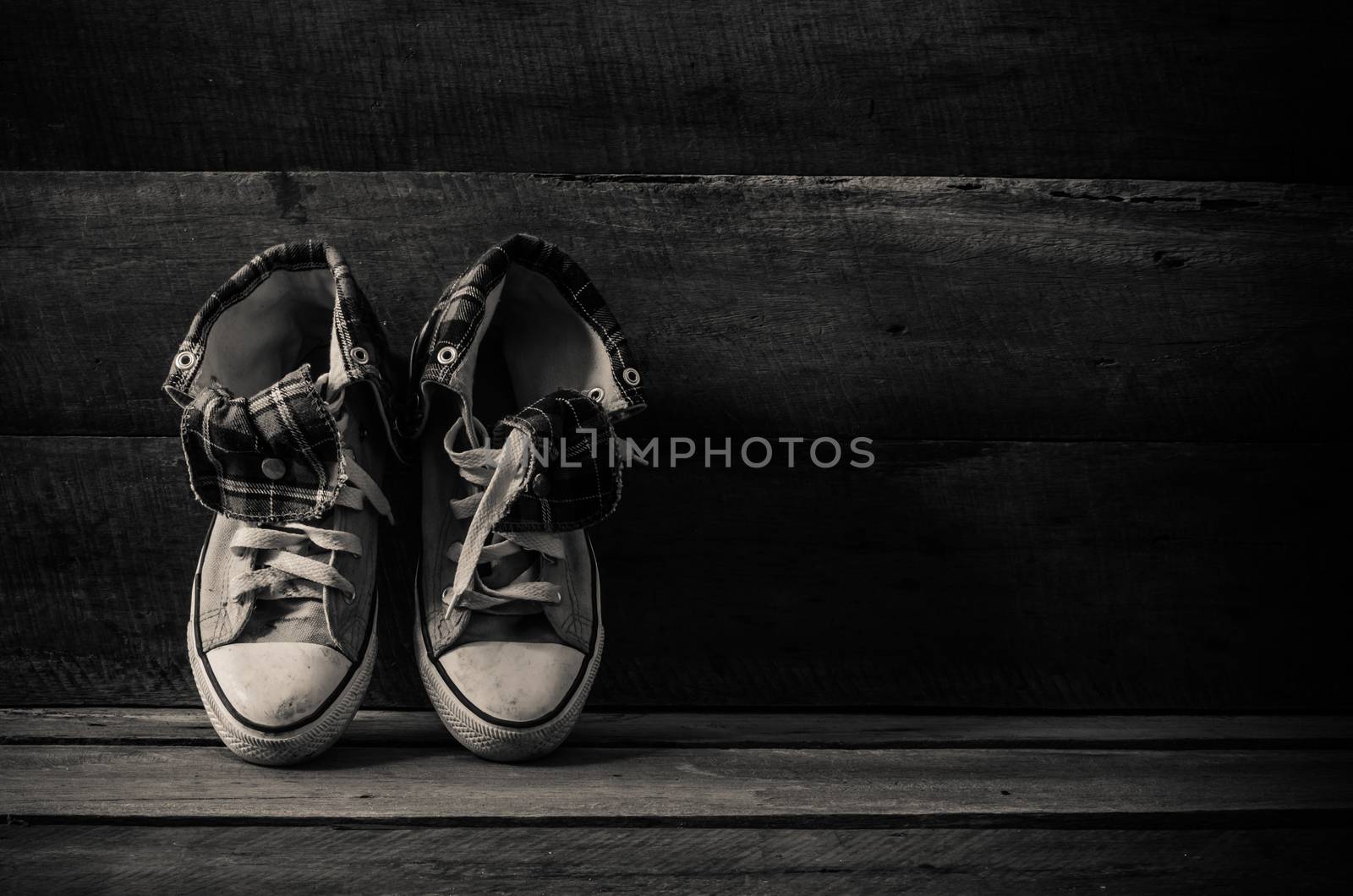 Sneakers on floor on wooden background,the black-white
