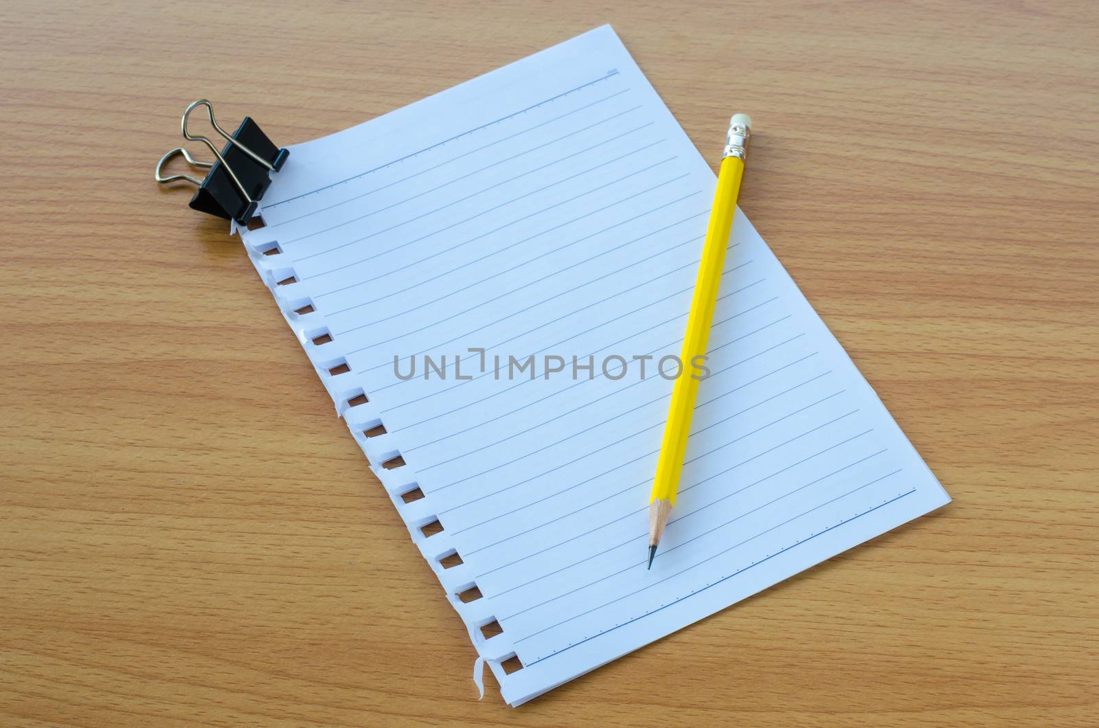 Note book paper with pencil by photobyphotoboy