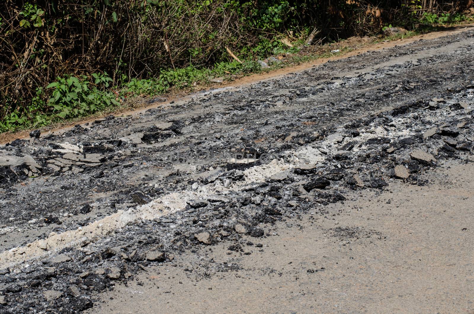 Road damage, with holes