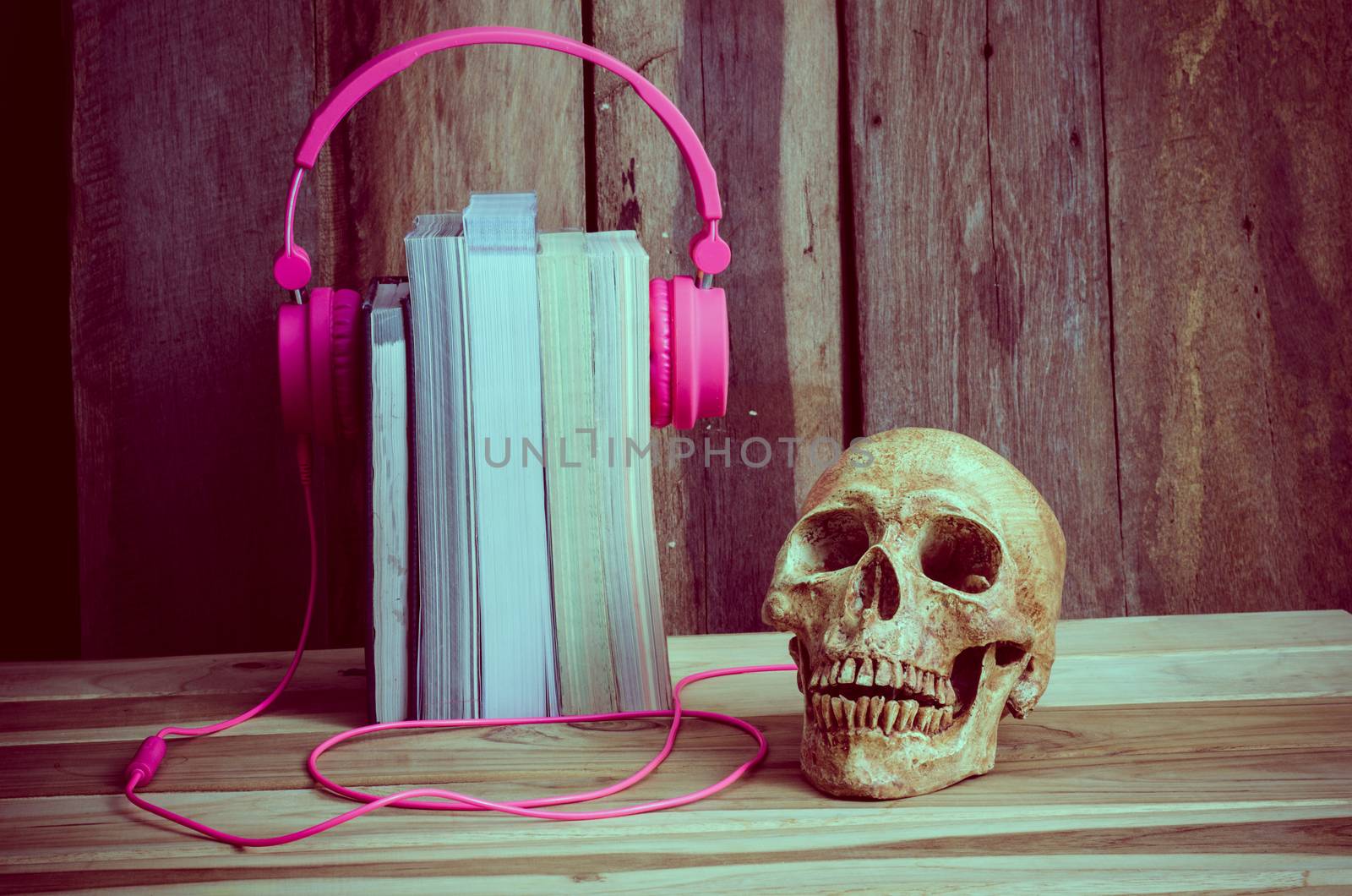 still life Headphones pink book skulls of modern educational concepts.