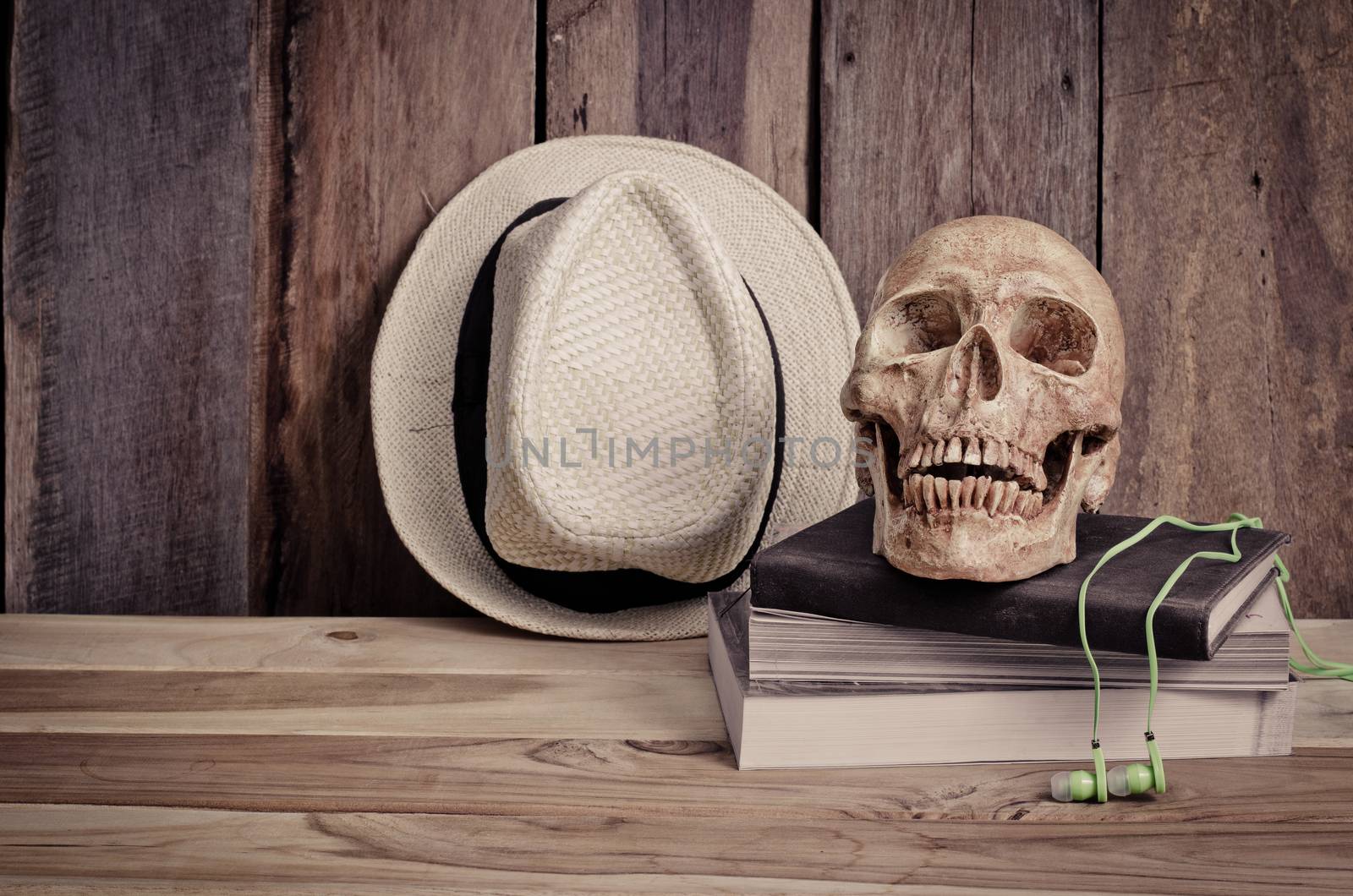 still life - skull on books and hat on wooden table by photobyphotoboy