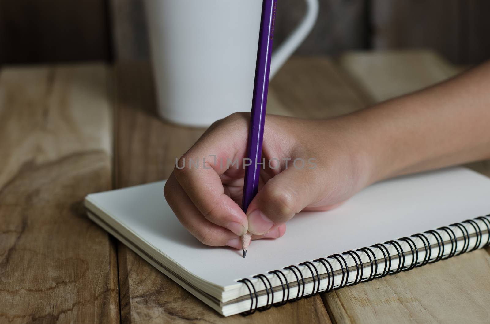 Hand drawing in open notebook on table by photobyphotoboy