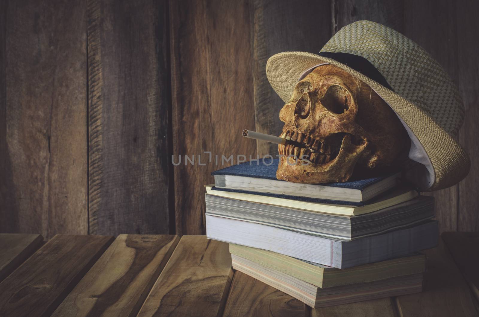 Still life skull . Cap machine weave and books on wooden background by photobyphotoboy