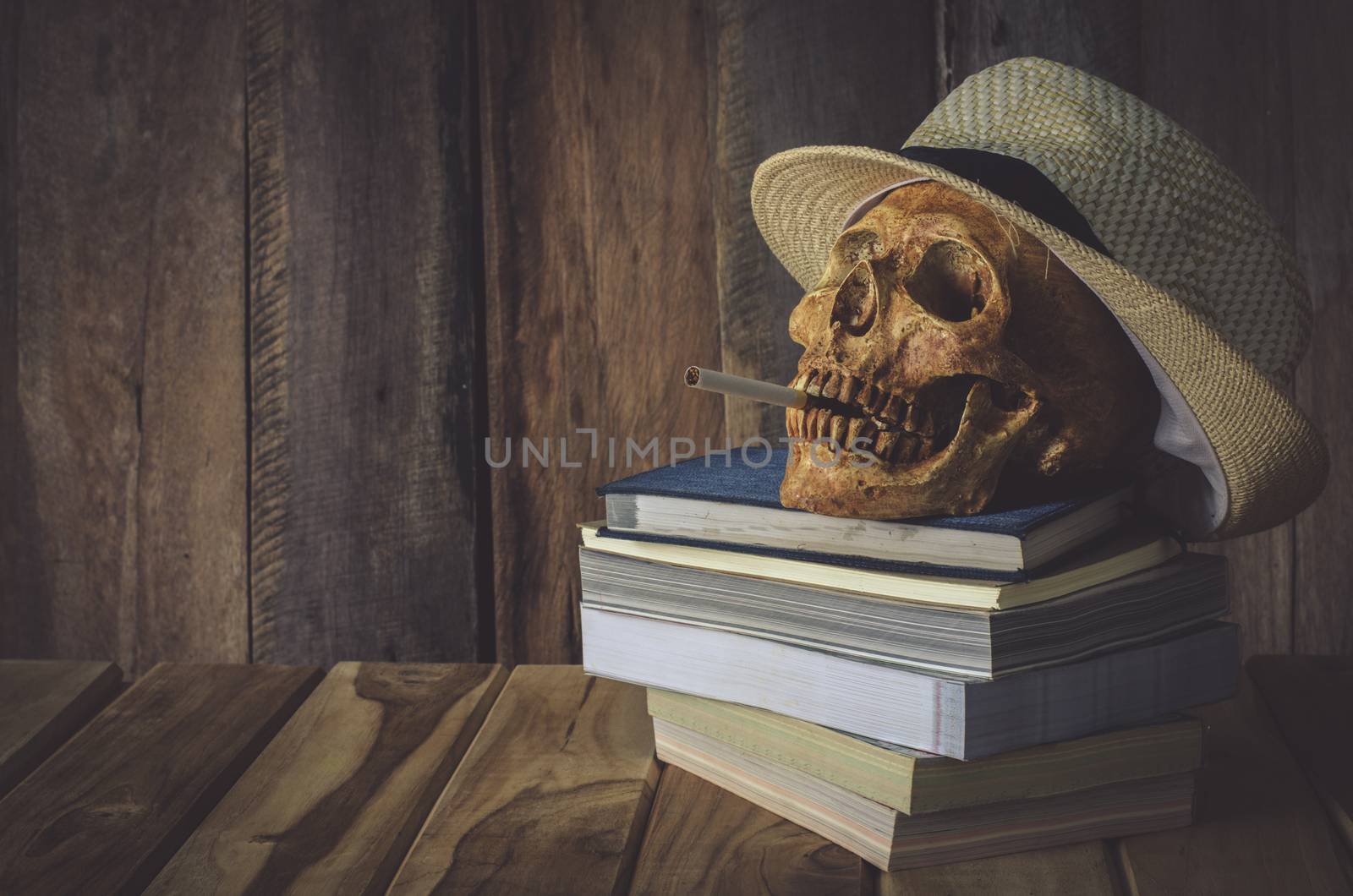 Still life skull . Cap machine weave and books on wooden background