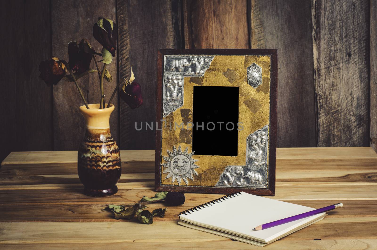 Still life picture frames, vases, dried rose notebook concept frequent memories.