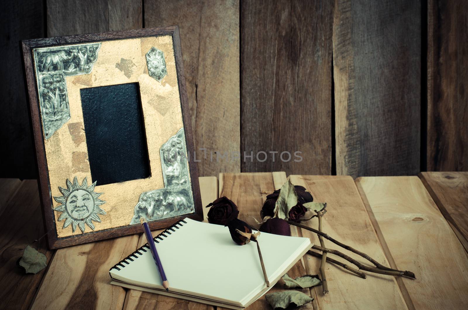 Still life picture frames, vases, dried rose notebook concept frequent memories.