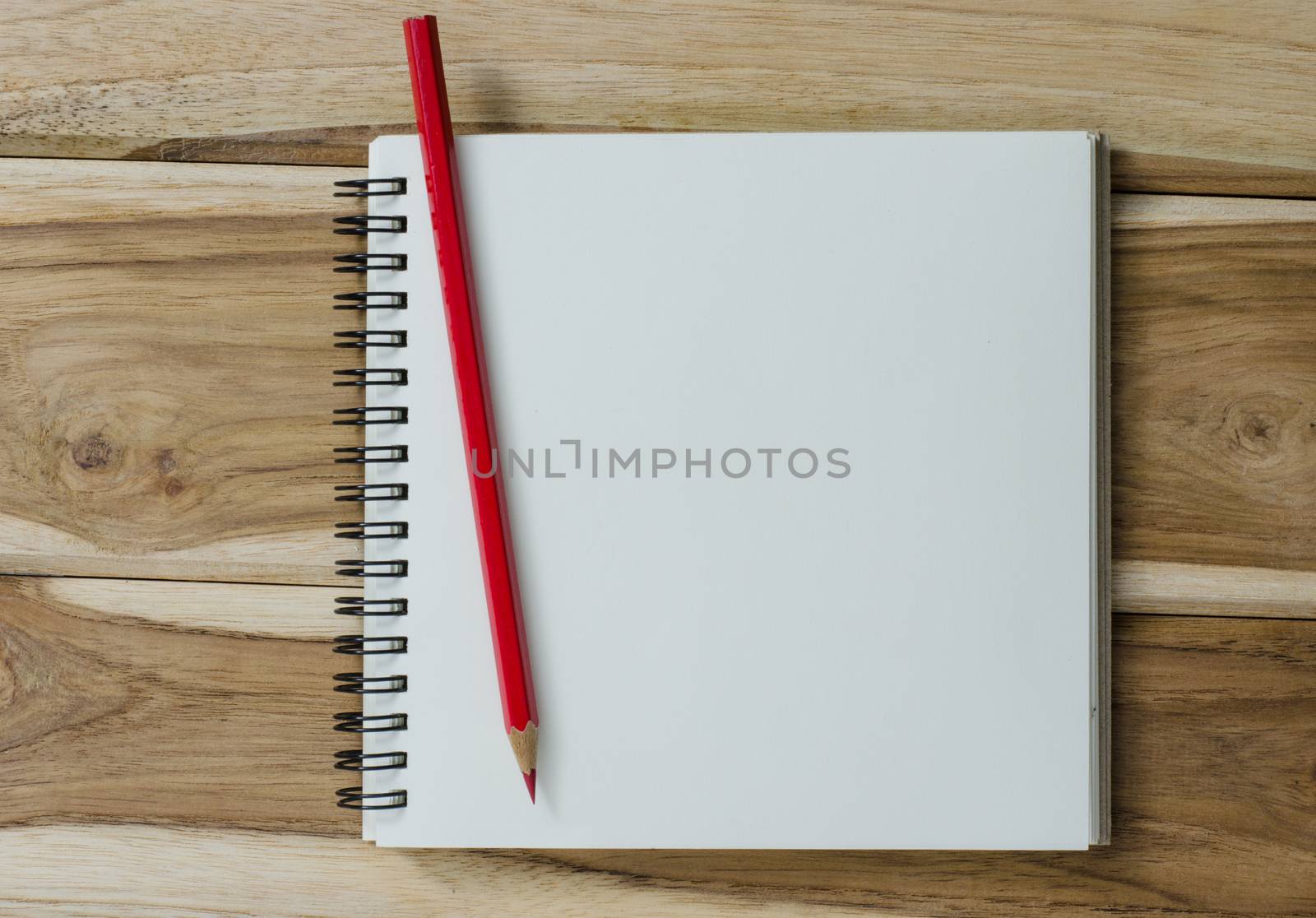 blank notebook with pencil on wooden table - still life