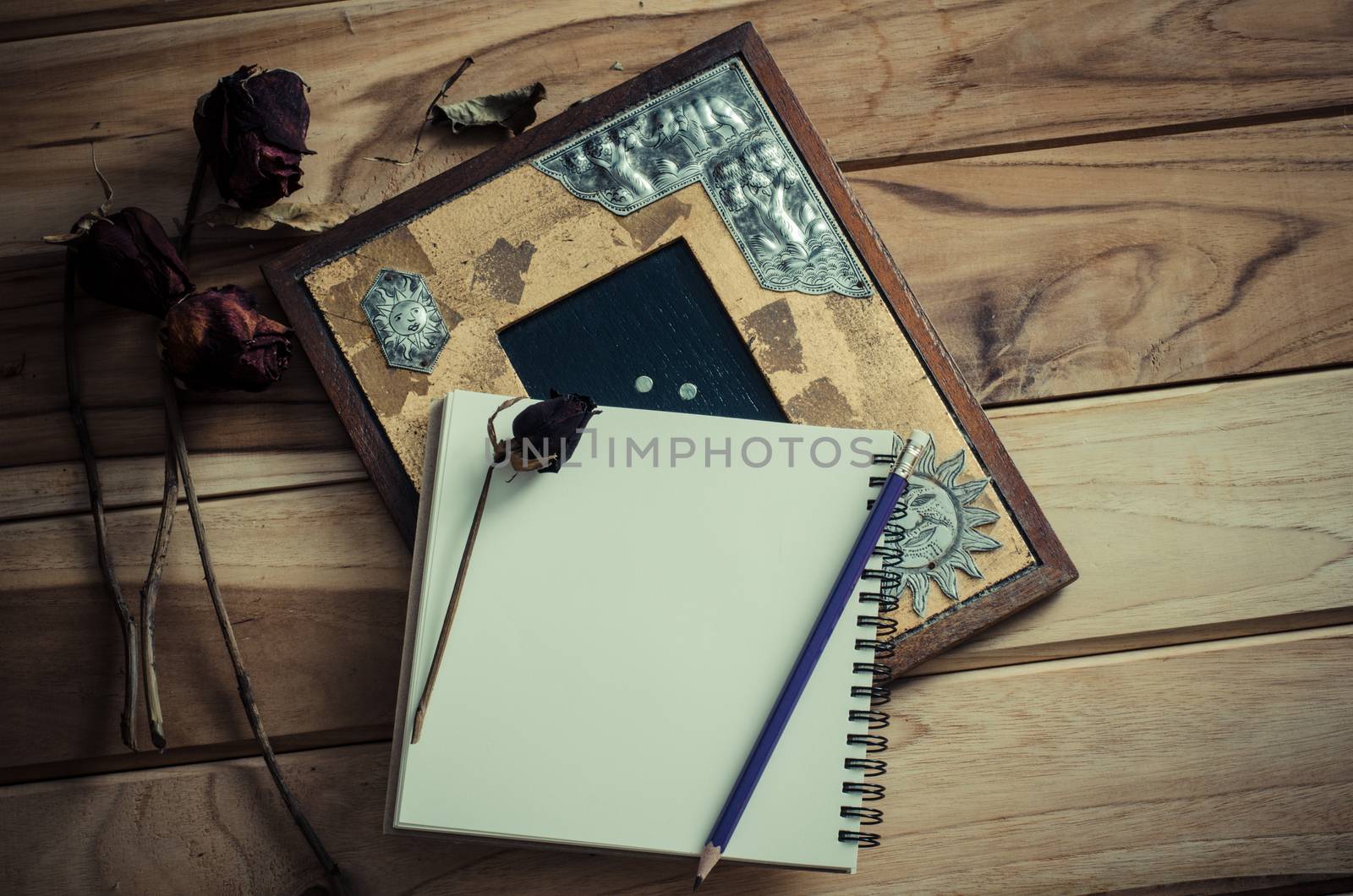 Still life picture frames, vases, dried rose notebook concept frequent memories.