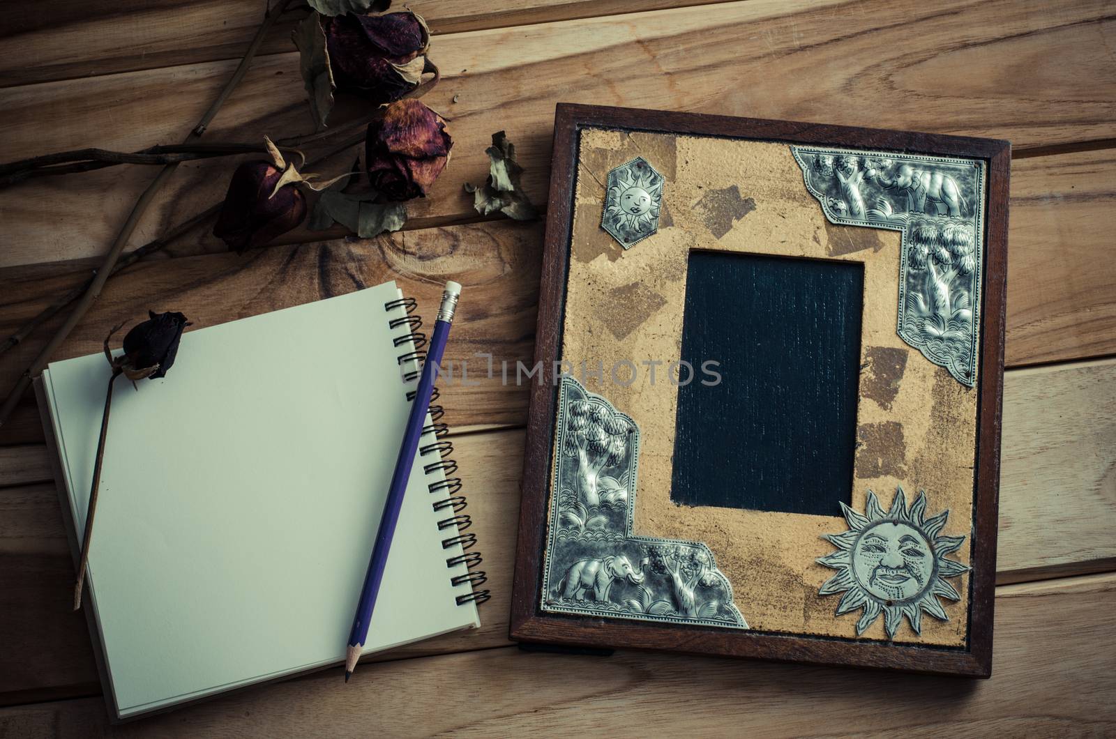 Still life picture frames, vases, dried rose notebook concept fr by photobyphotoboy