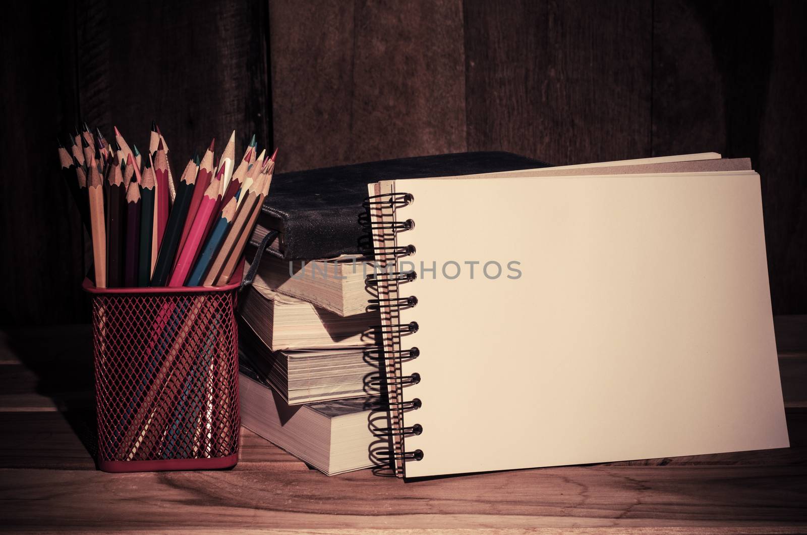 Still life color pencil and sketchbook on wooden background