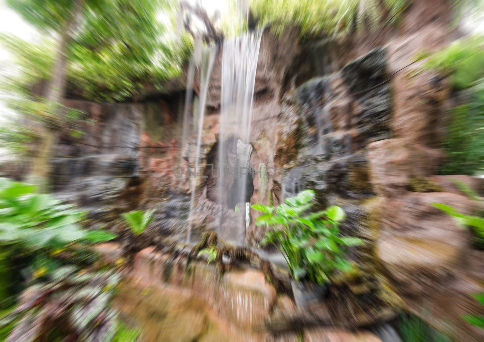 Blur beautiful waterfall in the forest trees