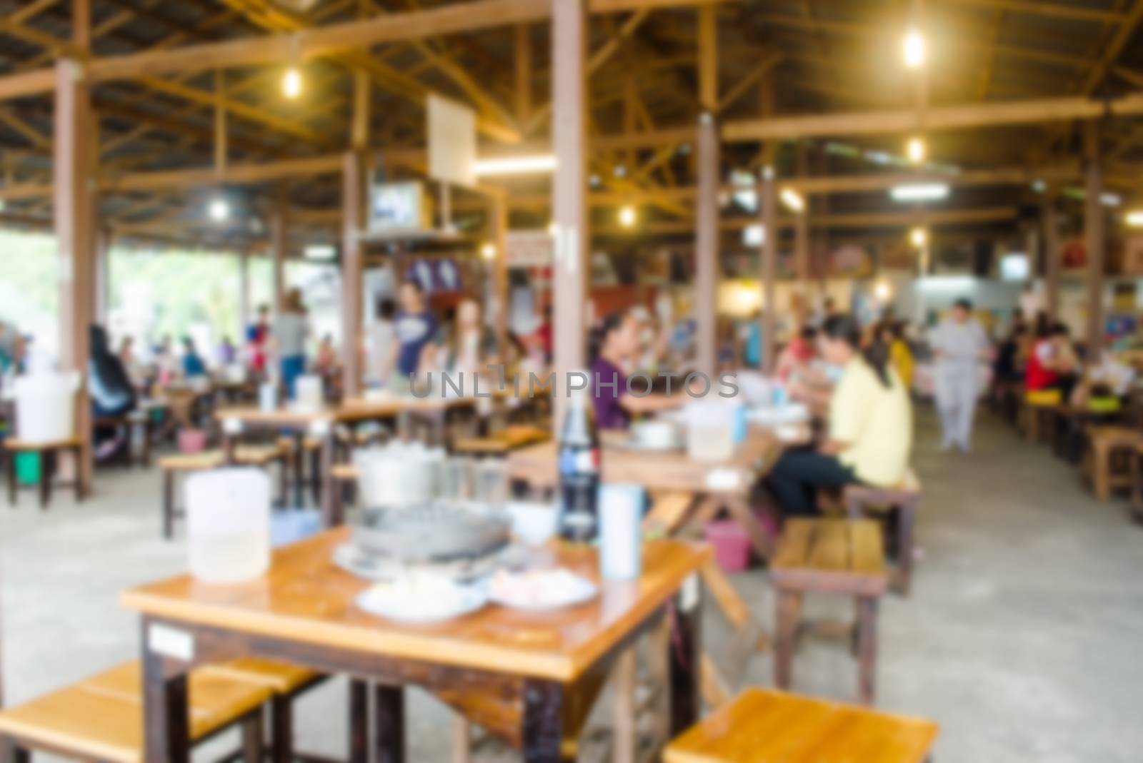 Blur restaurant with customers to access services.