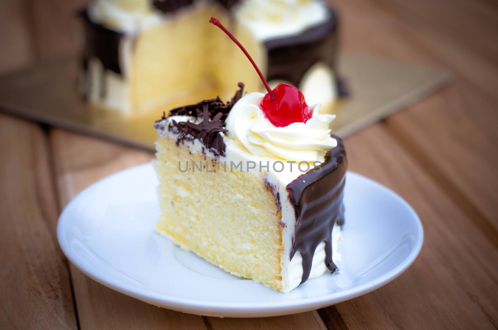 Birthday cake, vanilla Chocolate Cherry was divided pieces on a wooden table.