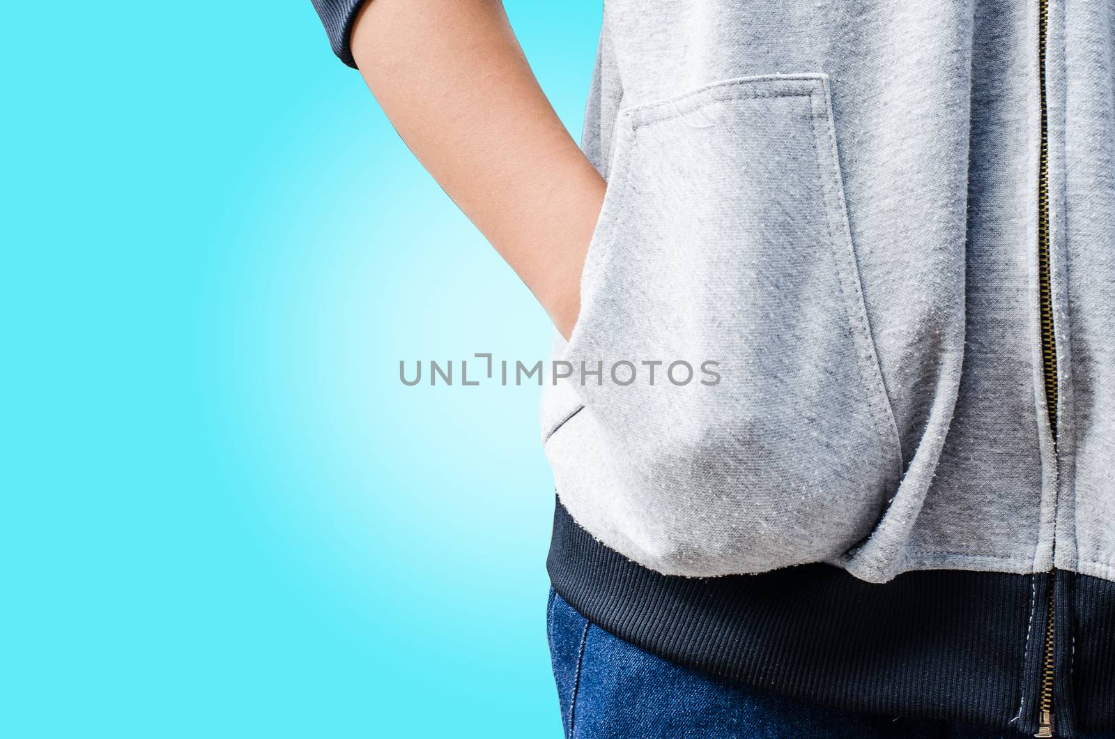 Hand in his pocket shirt on blue background.