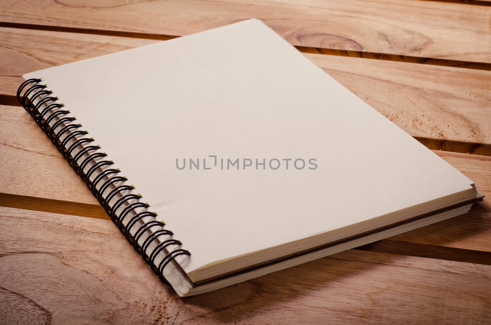 White notebooks laying on a wooden table