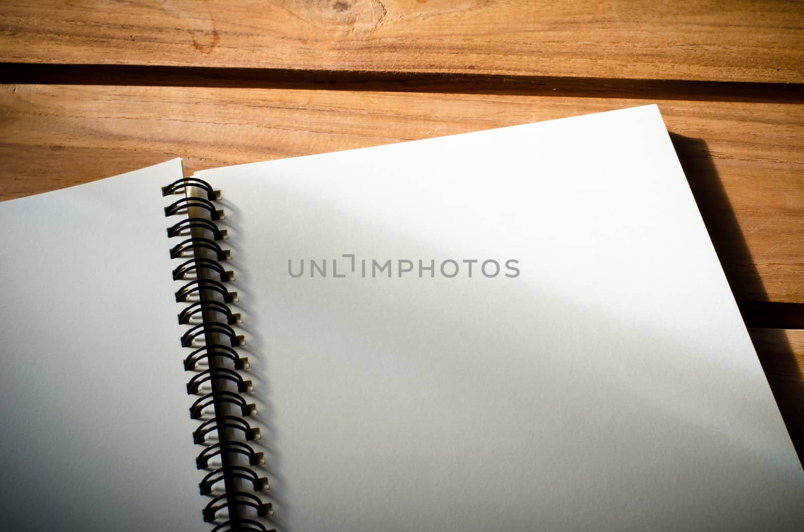 White notebooks laying on a wooden table