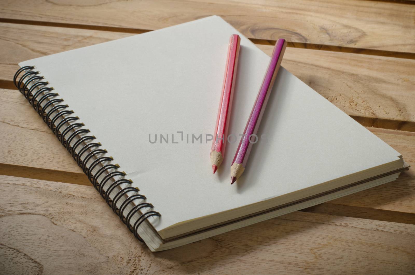 blank notebook with pencil on wooden table - still life
