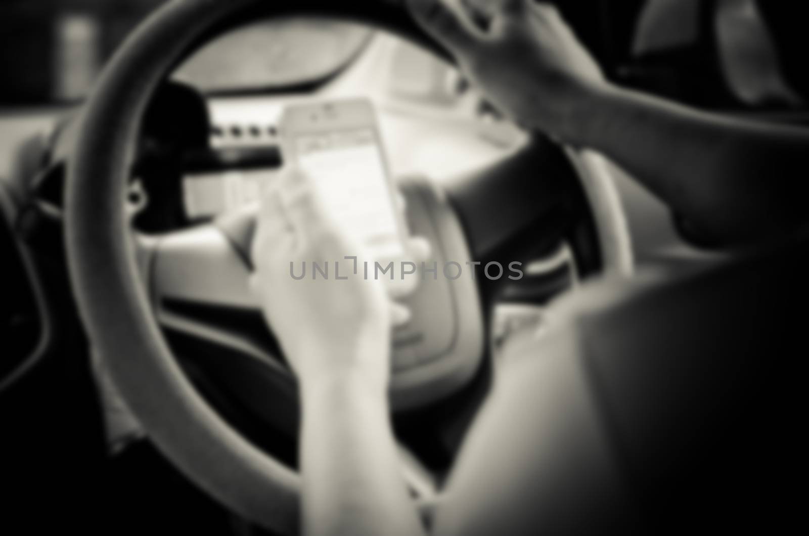Blur images of people using smartphones while driving, safety driving.