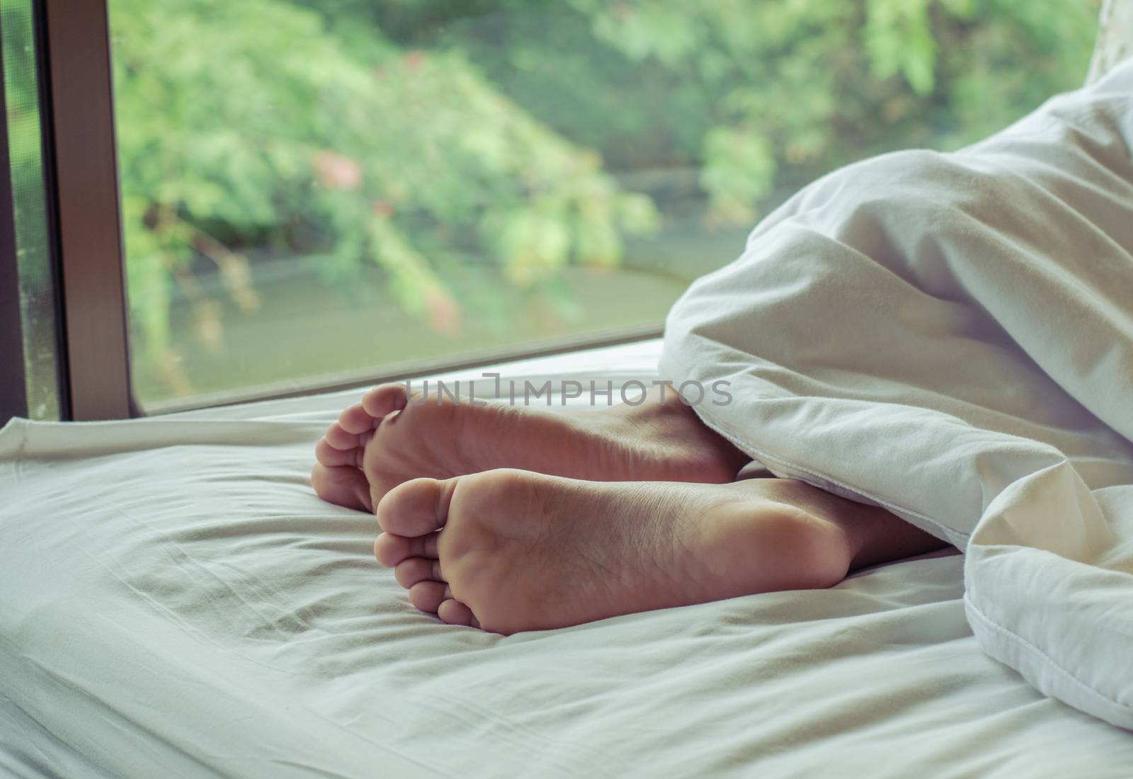 woman feet on the bed