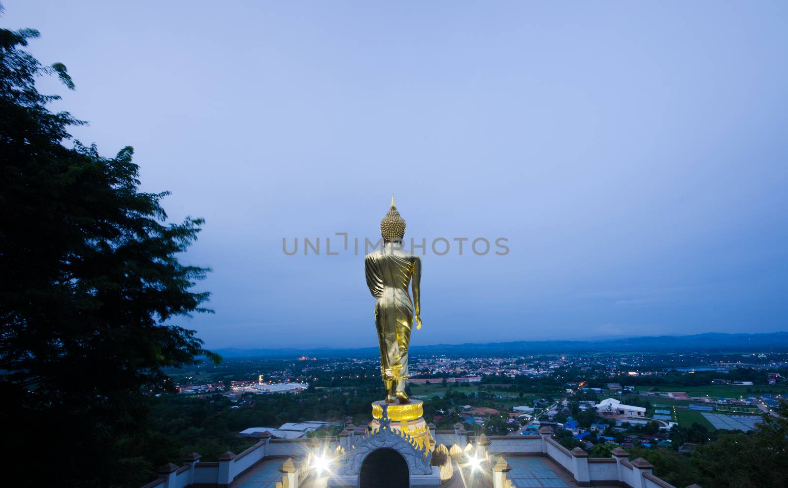 Golden Buddha standing on a mountain Wat Khao Noi, Nan, Thailand, surrounded by natural beauty.